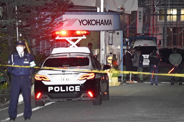<p>Police officers stand guard at the scene of a stabbing at the Yokohama Rubber Company in Mishima, west of Tokyo</p>