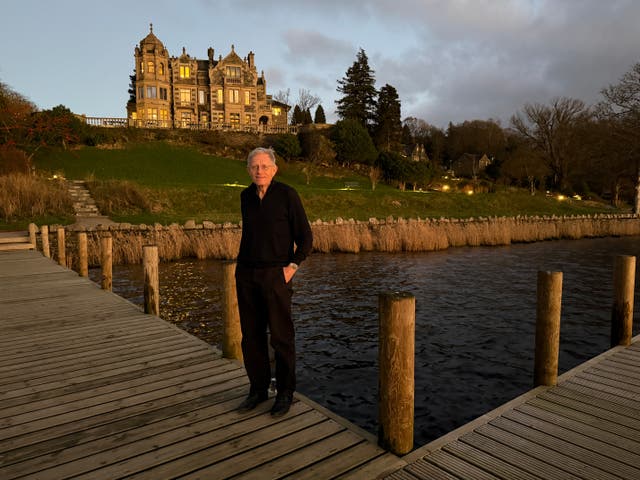 <p>Winter Windermere wonderland: Simon Calder by England’s biggest lake, with Langdale Chase as a backdrop</p>