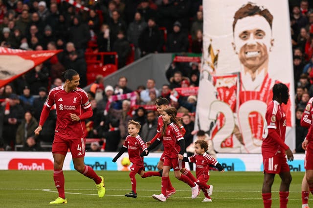 <p>The sons of Liverpool's late Portuguese forward Diogo Jota, Dinis and Duarte, and other family members take part in pre-game activities</p>