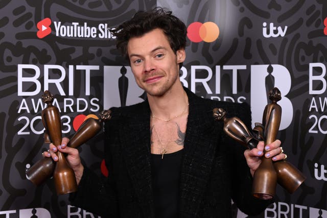 <p>Harry Styles poses with his Brit awards</p>