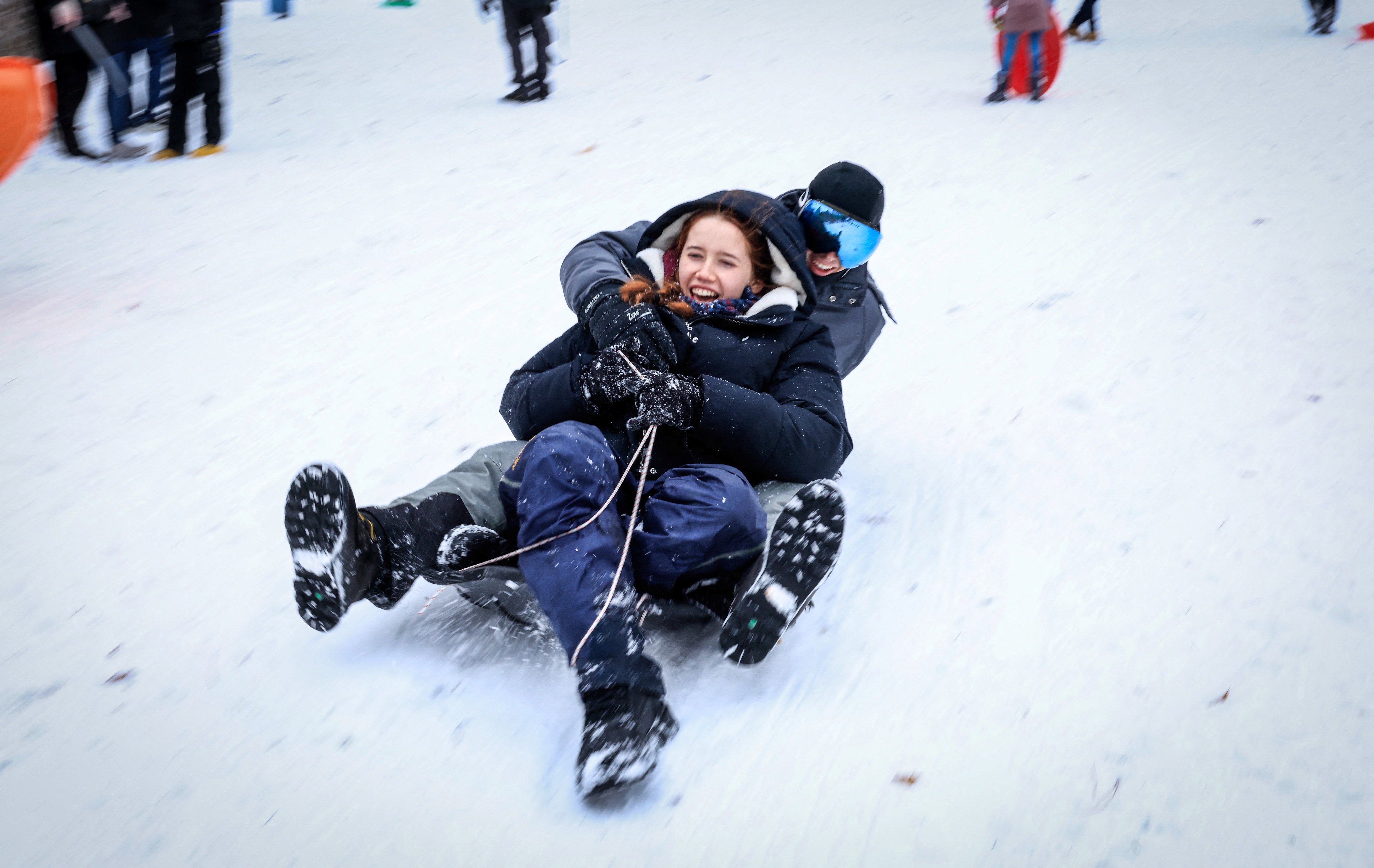 People play in the snow in Central Park in Manhattan, New York