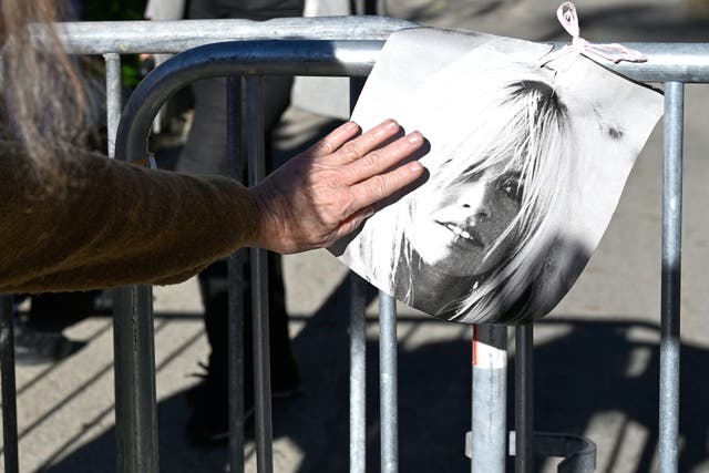 <p>A woman touches a poster showing actor Brigitte Bardo near her home in Saint-Tropez, southern France, Sunday, Dec. 28, 2025 after the French 1960s sex symbol who became one of the greatest screen sirens of the 20th century and later a militant animal rights activist and far-right supporter, has died. She was 91. (AP Photo/Philippe Magoni)</p>