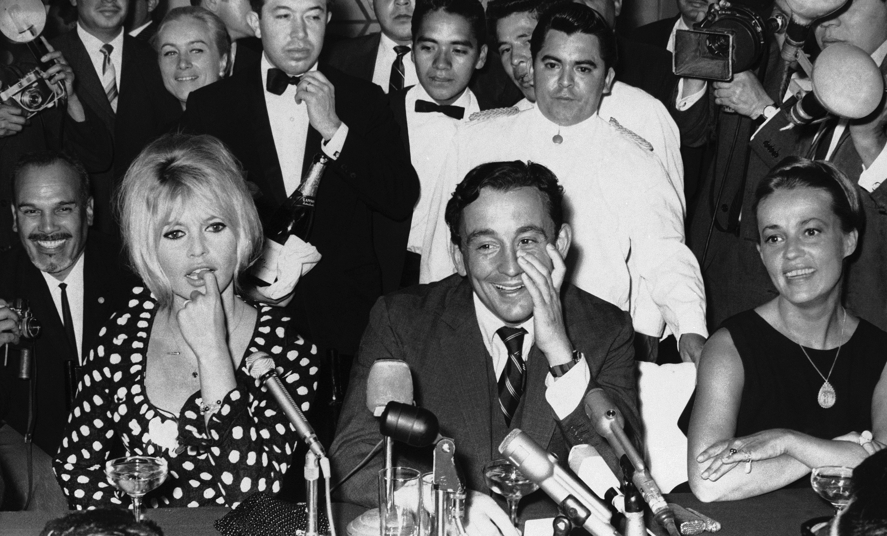 French Actress Brigitte Bardot, left, attends a news conference in Mexico City, Jan. 18, 1965. Seated next to her is producer Louis Malle and at right is French actress Jeanne Moreau. (AP Photo/File)