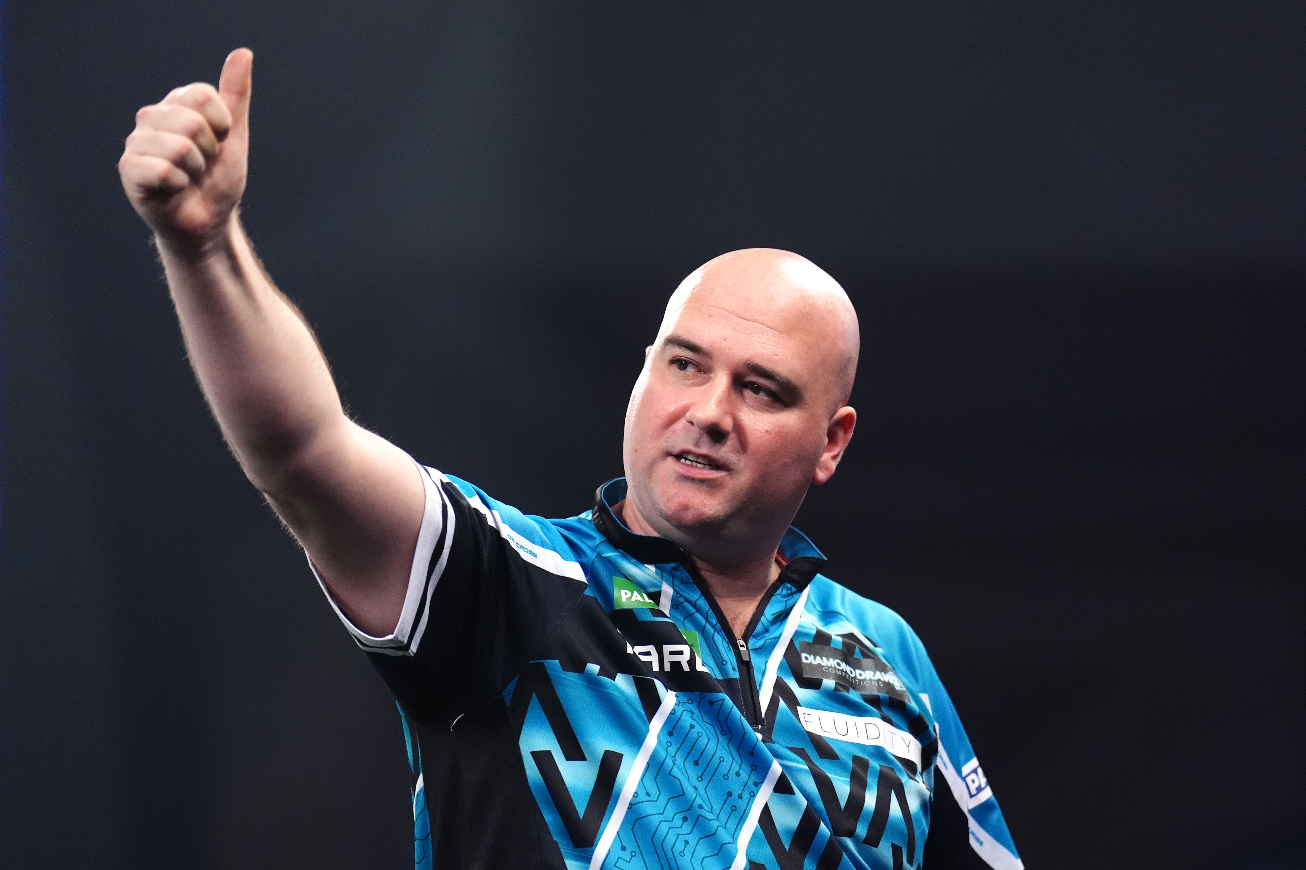 Former world champion Rob Cross will play Luke Littler in the last 16 at the World Darts Championship (John Walton/PA)
