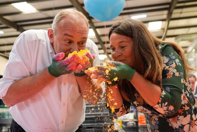 Liberal Democrats leader Sir Ed Davey and Mid Dorset and North Poole MP Vikki Slade making bath bombs during a visit to the Lush factory in Poole, Dorset (PA)