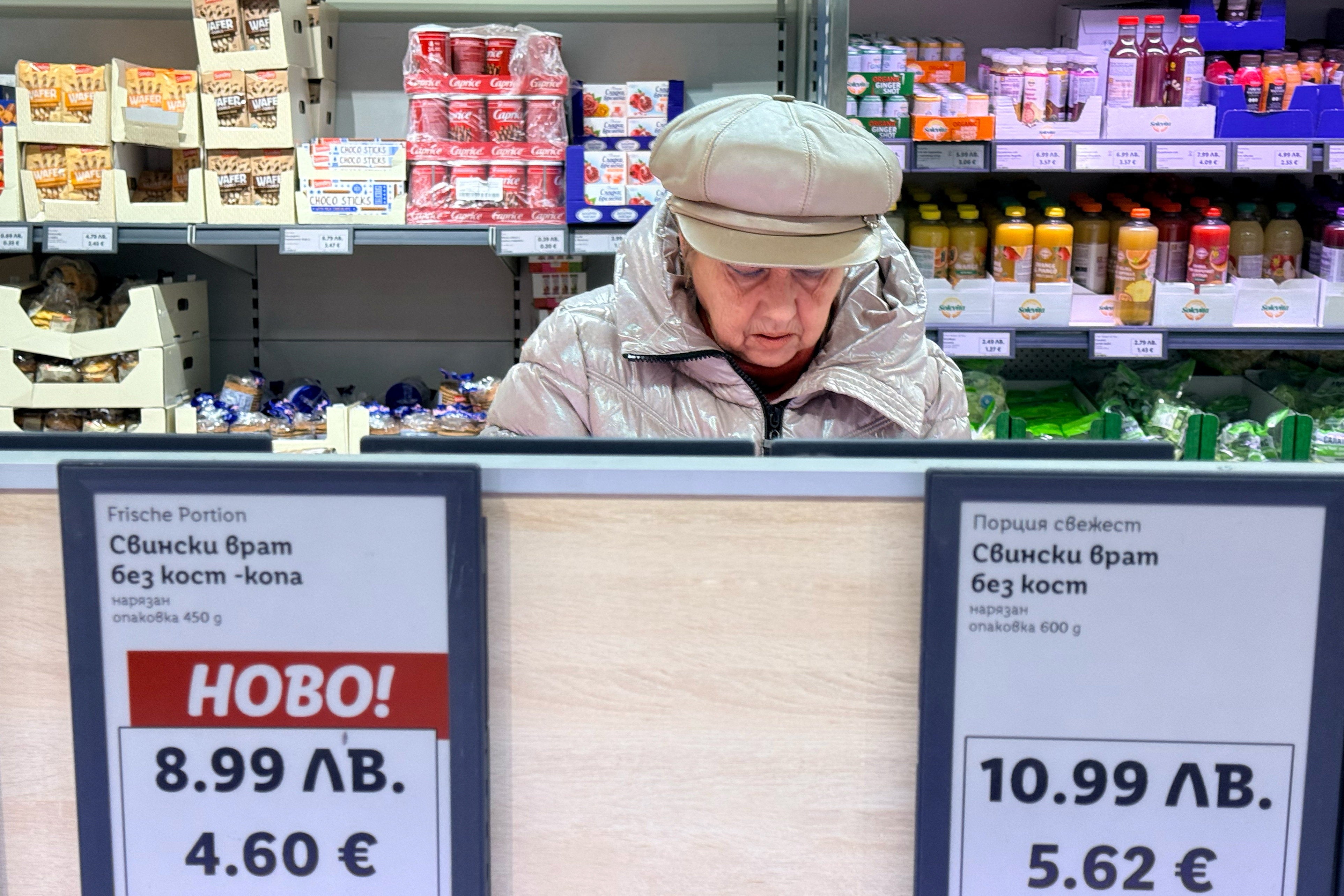 <p>A woman shops inside a Lidl store in Sofia where prices are already displayed in both currencies</p>