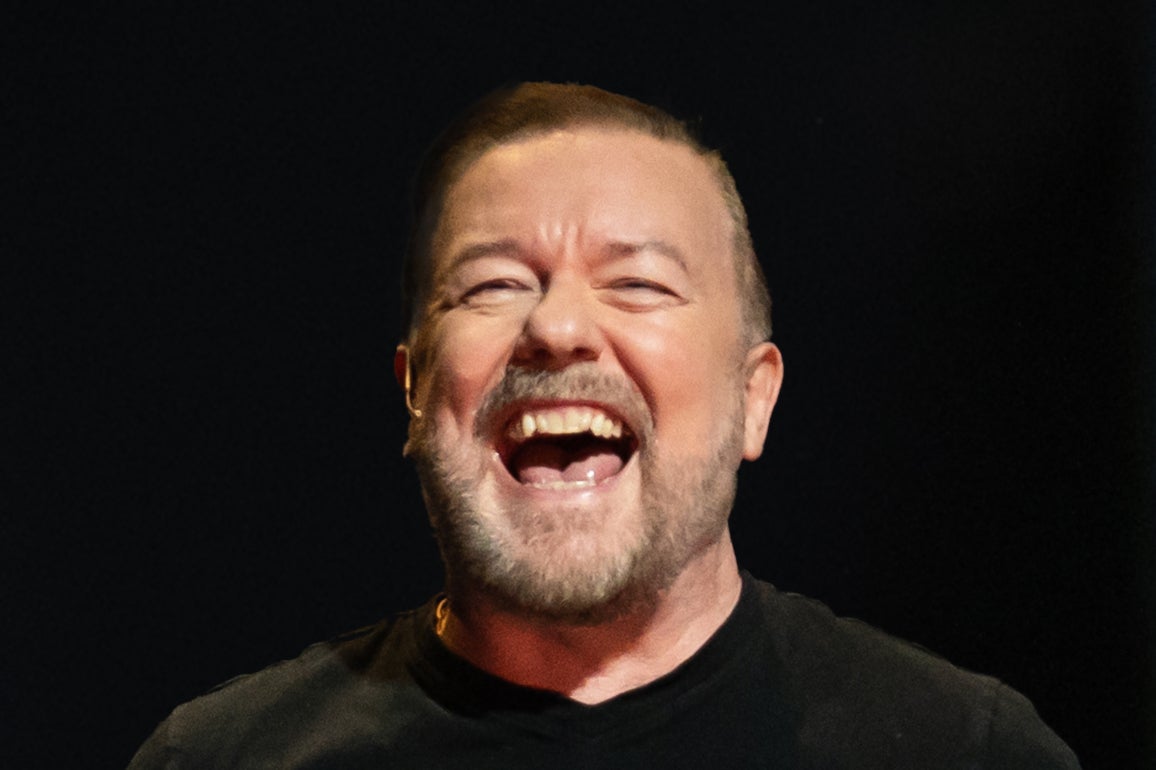 <p>Ricky Gervais laughs onstage during his latest Netflix comedy special 'Mortality'</p>