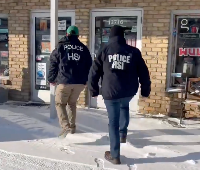 <p>Two Homeland Security Investigations agents conduct inquiries at a small business in Burnsville, Minnesota, in a video posted by the Department of Homeland Security on Monday December 29, 2025</p>