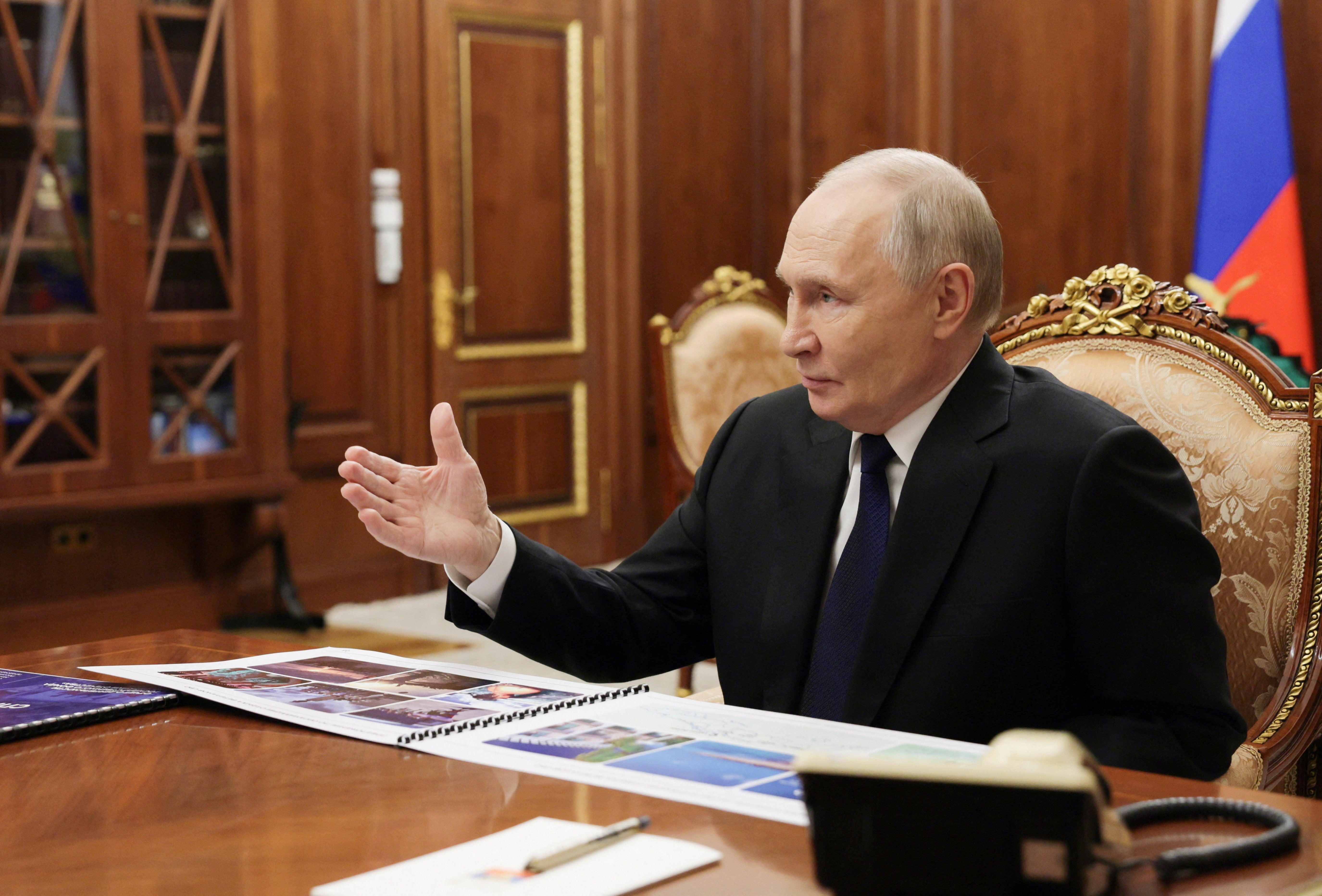 Vladimir Putin attends a meeting in the Kremlin