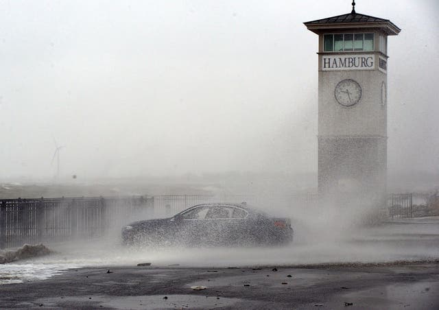 <p>Waves are shown crashing against the pier in Hamburg, New York, on Monday</p>