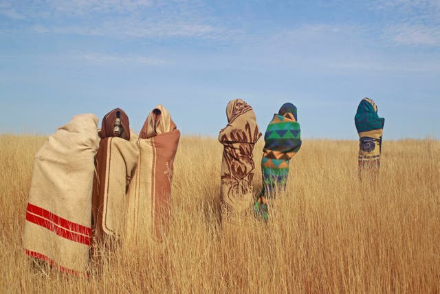 <p>Xhosa boys stand in a field during traditional Xhosa male circumcision ceremonies into manhood in South Africa</p>