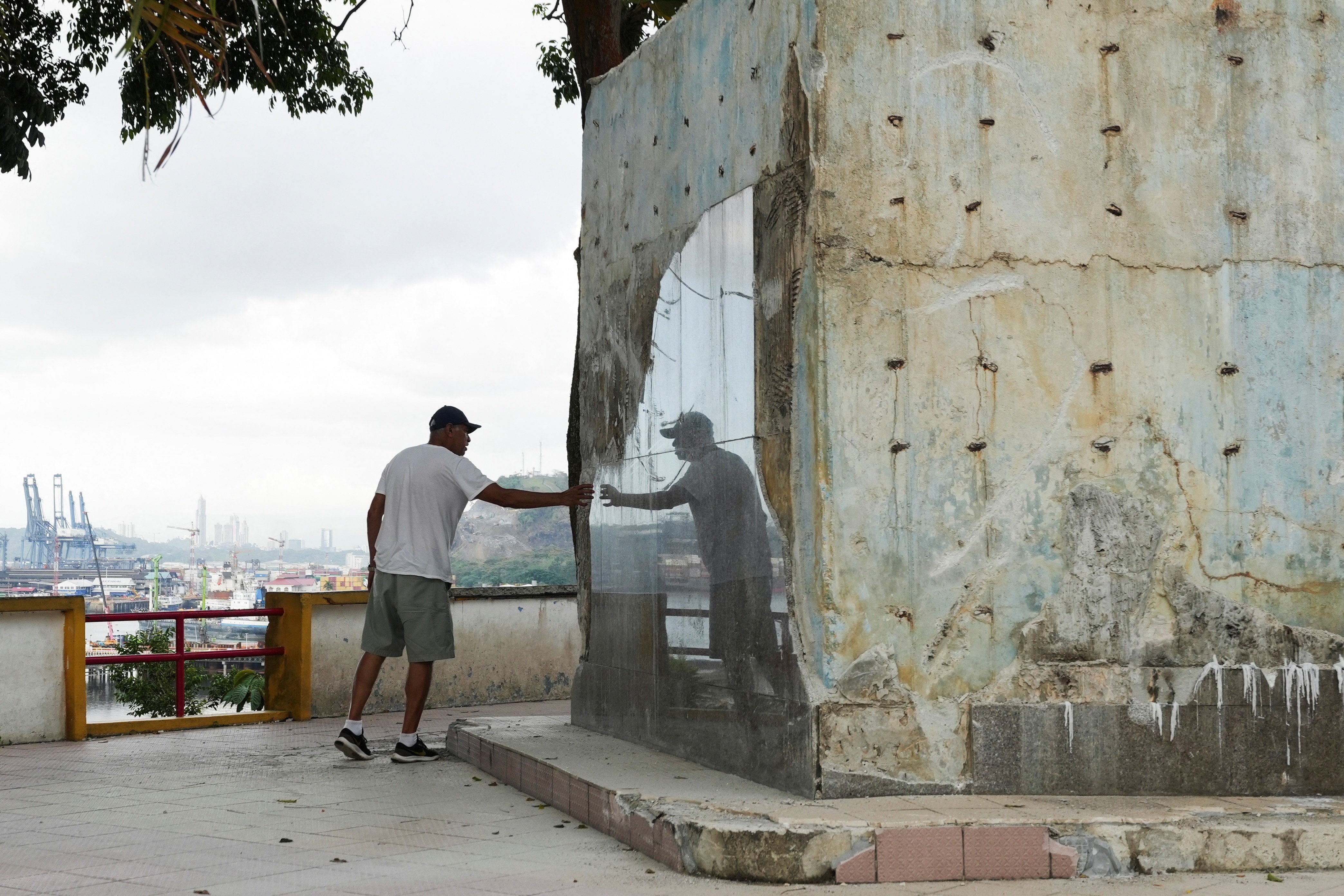 <p>A man touches the remains of a monument honouring Chinese workers after its demolition in Arraijan, Panama, on 29 December 2025</p>