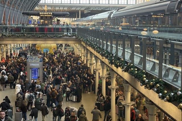 Delayed passengers at St Pancras train station, central London (Jonathan Brady/PA)