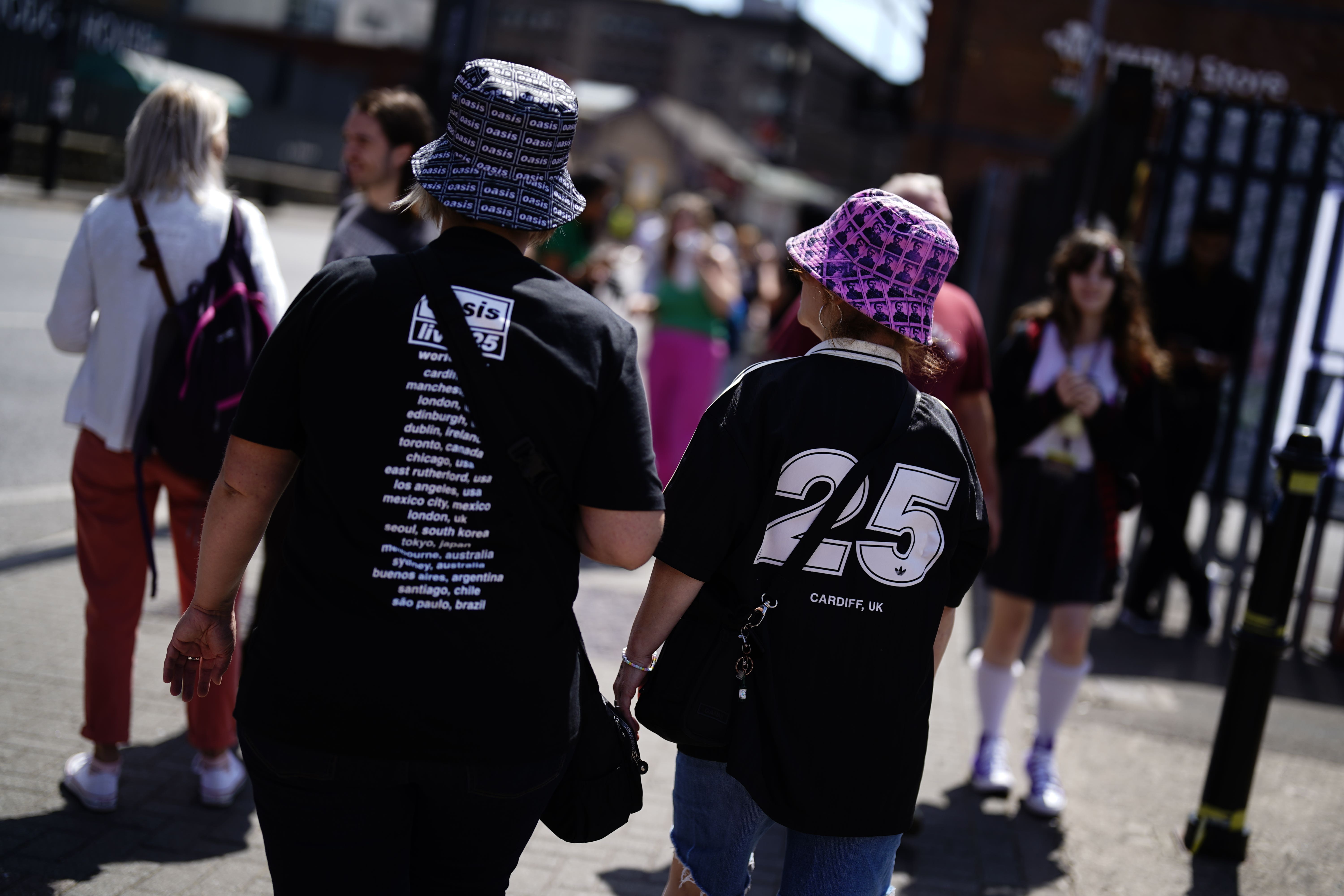 Oasis fans wearing bucket hats outside the Principality Stadium, Cardiff (PA)