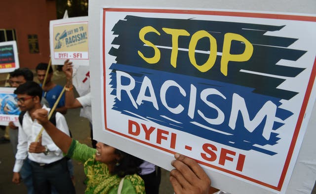 <p>Indian social activists shout slogans and hold signs during a protest condemning an attack on students from African countries in Mumbai on 3 April 2017</p>