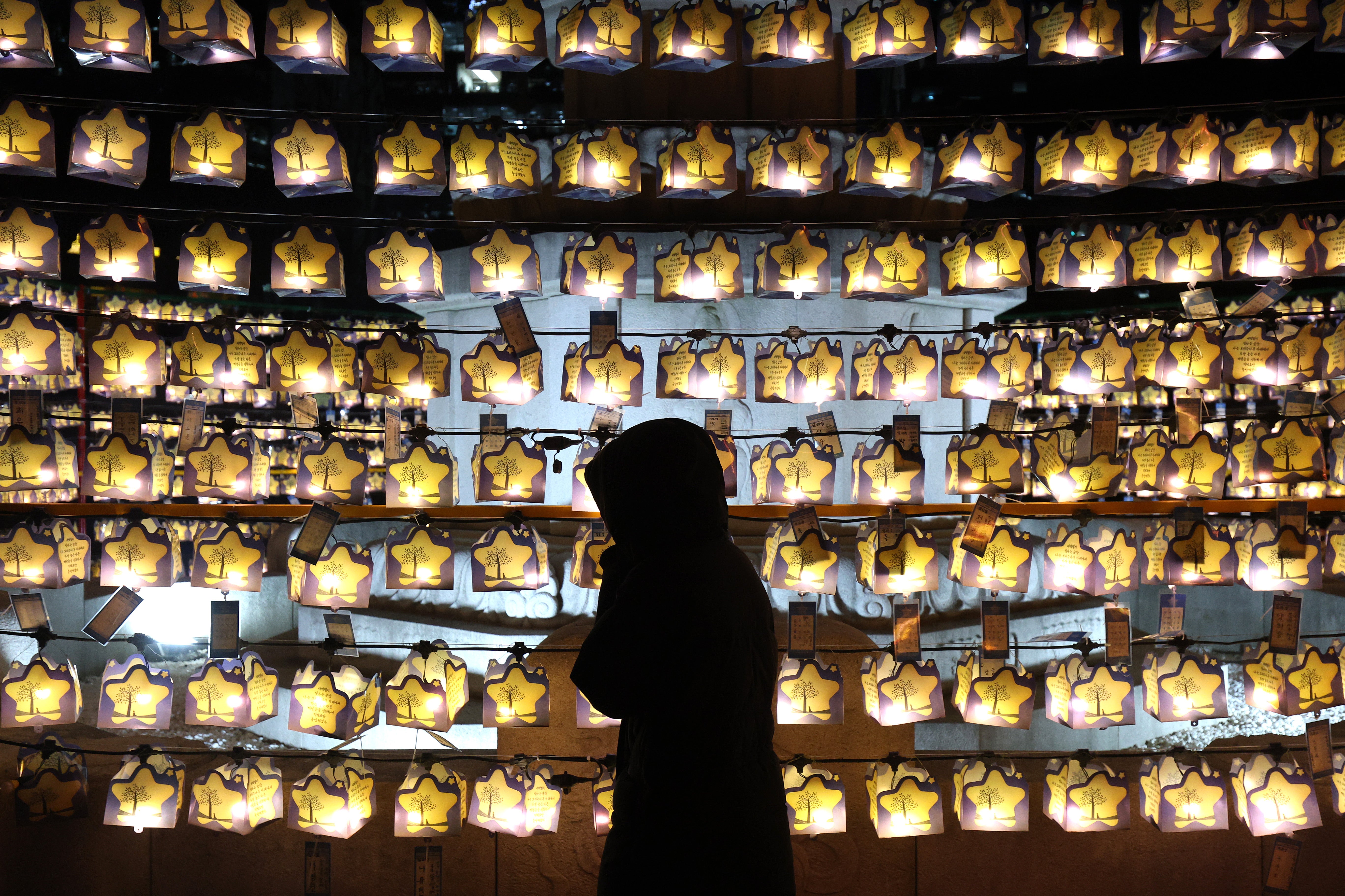 A woman prays at Jogyesa buddhist temple during the New Year's Eve in Seoul, South Korea