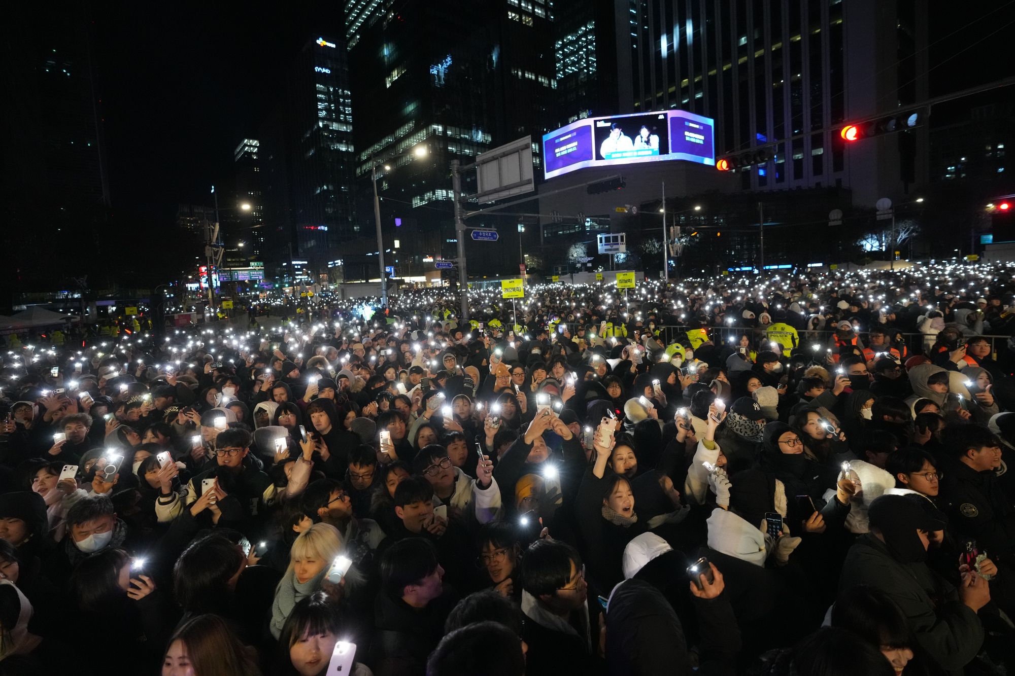 People gather before the New Year's countdown event in front of the Bosingak pavilion where the annual New Year's bell-ringing ceremony is held in Seoul, South Korea