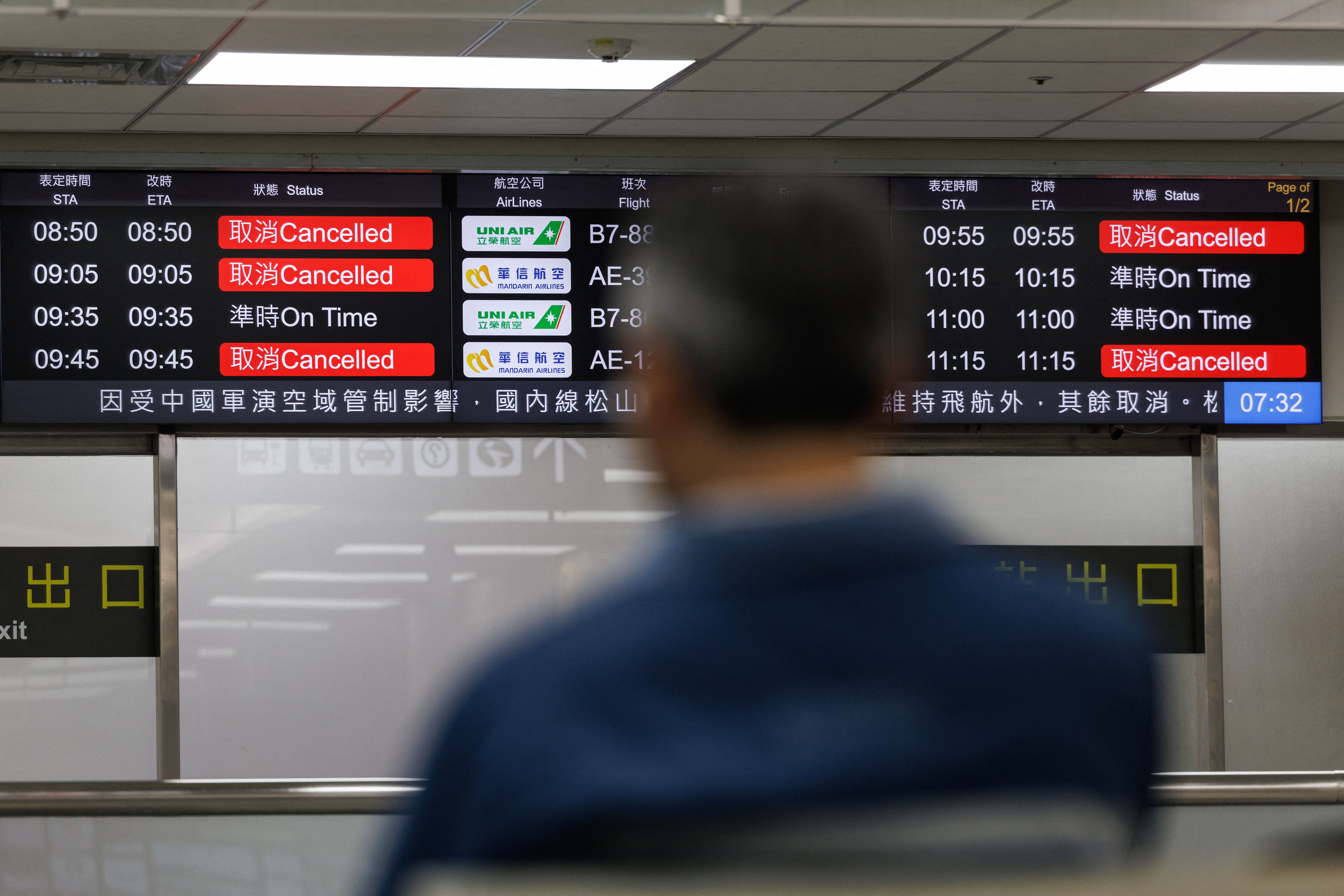 Flight information display boards show cancelled flights at Taipei Songshan Airport amid flight disruptions in Taipei from China's military drills