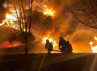 Firefighters work at the site of a Russian drone strike in Volyn region on 1 January