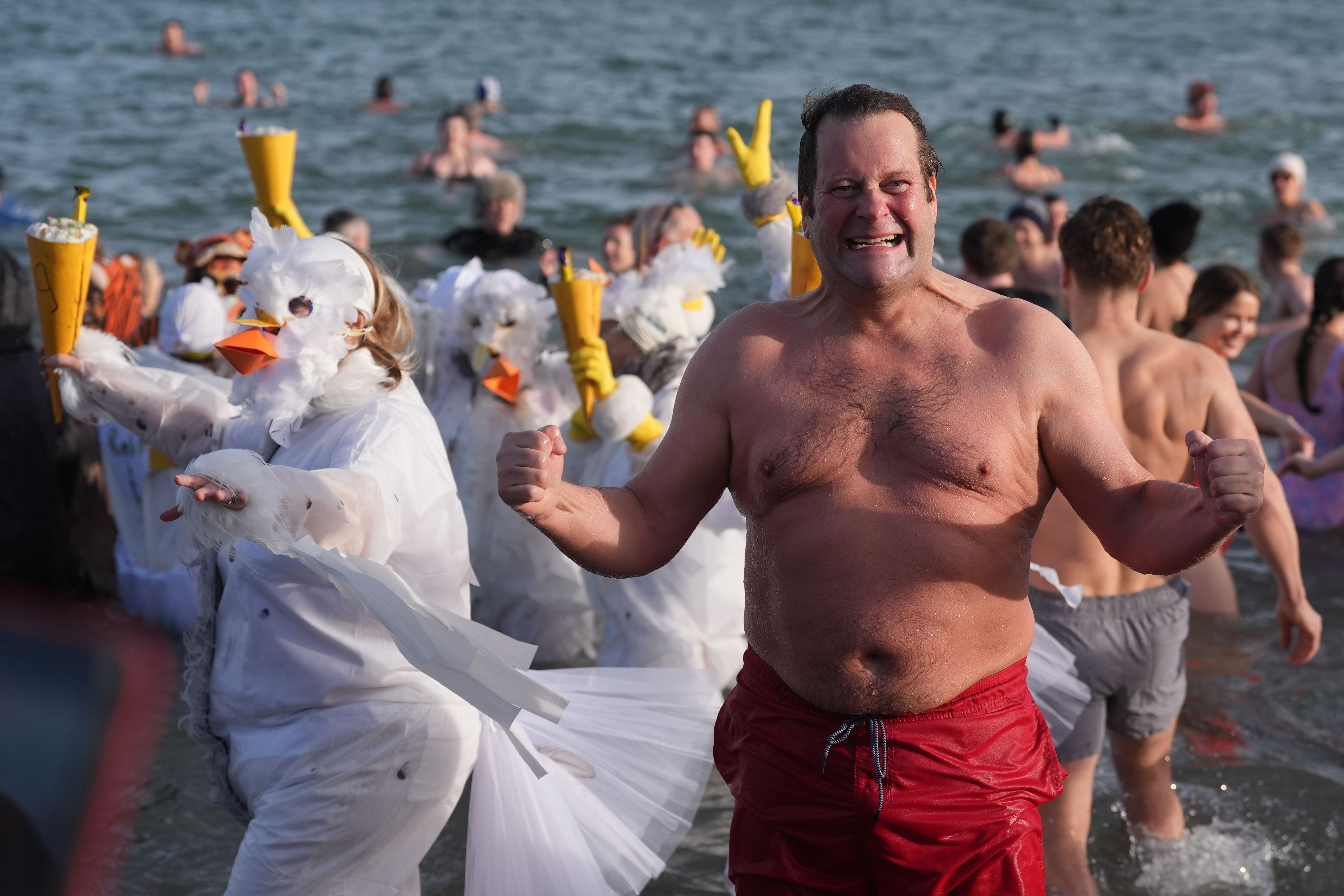 Swimmers take part in the annual New Year’s Day charity swim on Bray seafront in County Wicklow (Brian Lawless/PA)