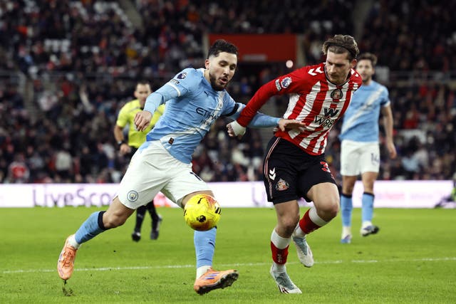 Manchester City’s Rayan Cherki and Sunderland’s Dennis Cirkin battle for the ball (Richard Sellers/PA)