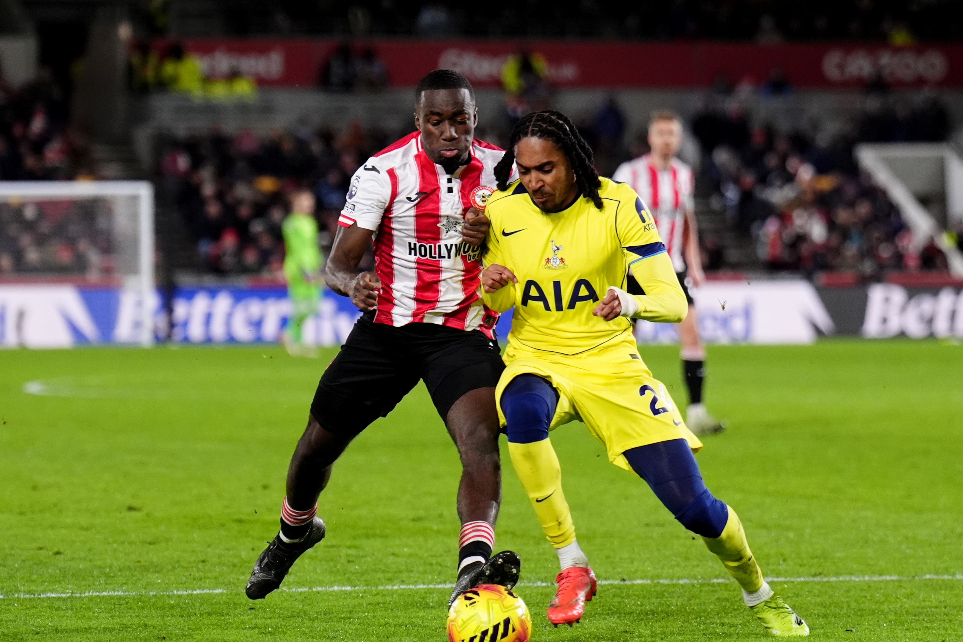 Brentford’s Michael Kayode (left) and Tottenham’s Djed Spence battle for the ball during the Premier League match at the Gtech Community Stadium, London. Picture date: Thursday January 1, 2026.