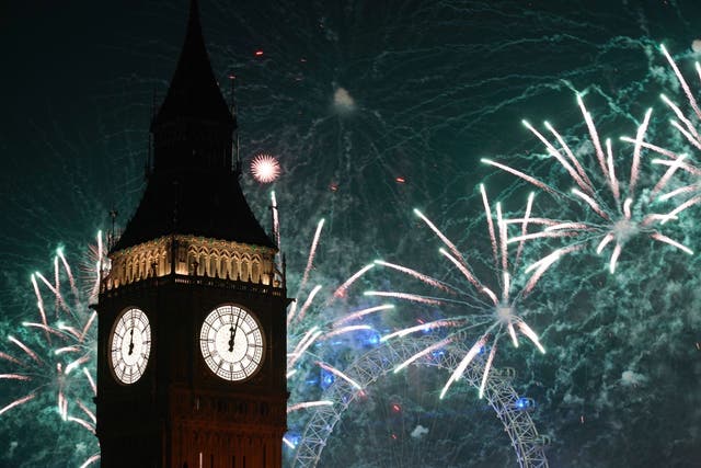 <p>Fireworks light up the sky over Elizabeth Tower and the London Eye in central London during the New Year celebrations</p>
