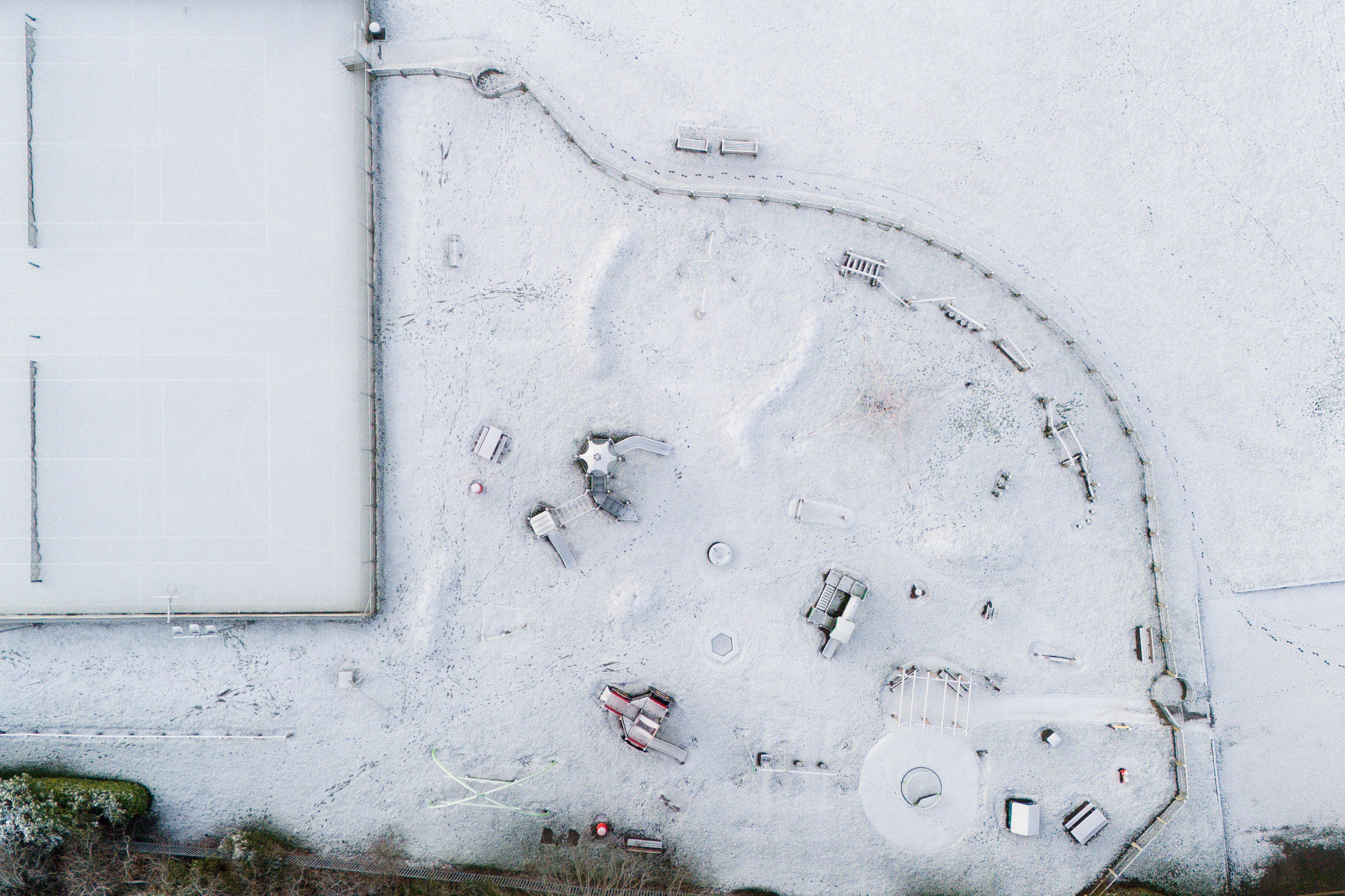Snow covers a playground and tennis courts in Warwickshire (Jacob King/PA)