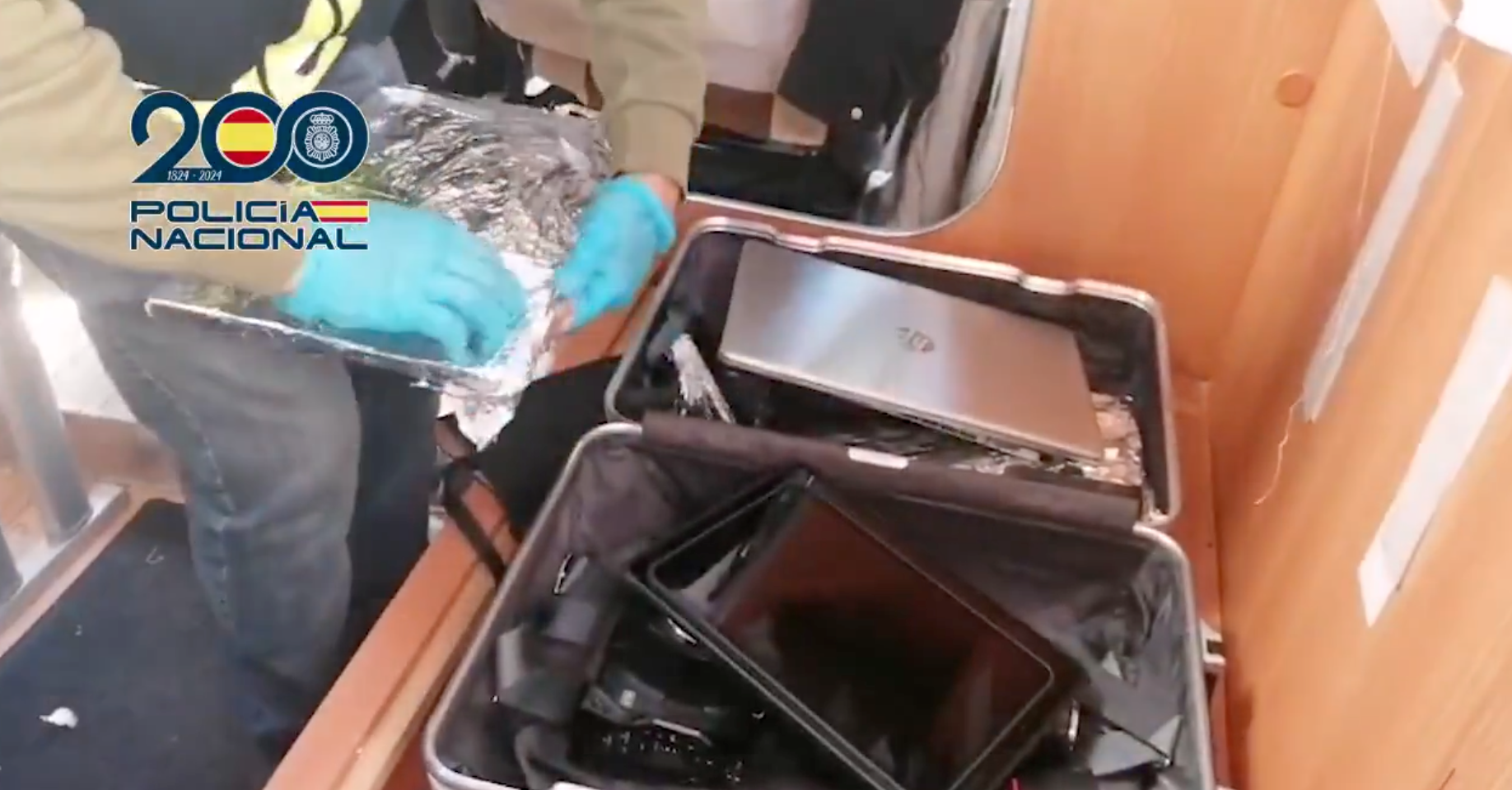 Officers unwrap foil from laptops