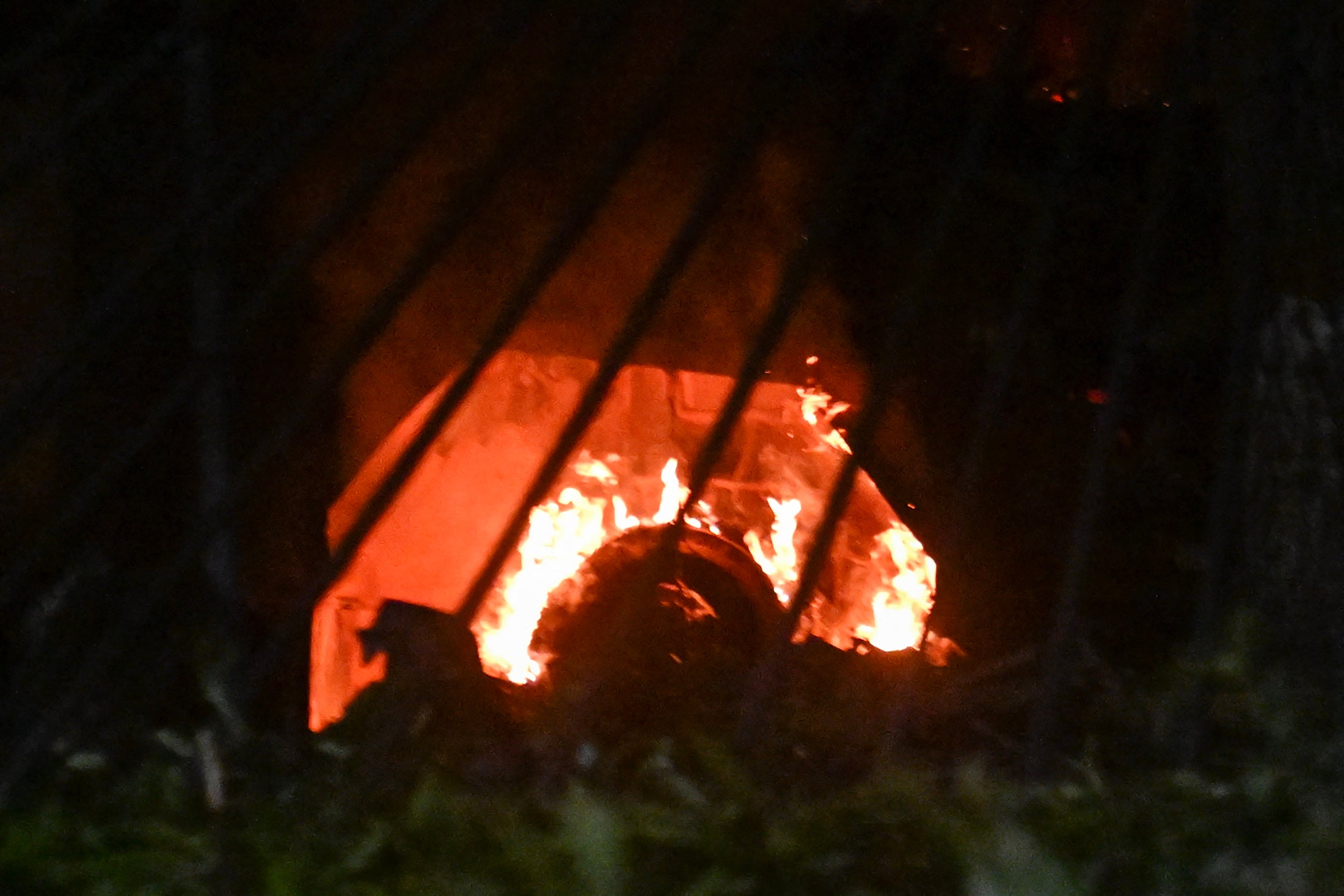 <p>A vehicle burns at La Carlota air base in Caracas </p>