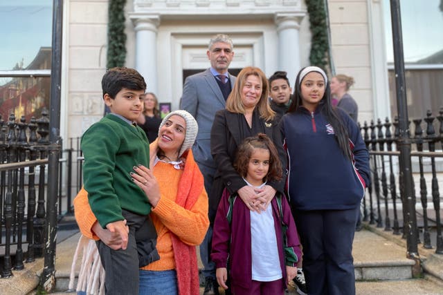 Buchra Abdul-Bari holds her son Mohammed, six, and stands with her 14-year-old daughter Ghazal, 12-year-old son Zainaldeen and eight-year-old daughter Kinzy along with Palestinian ambassador Dr Jilan Wahba Abdalmajid at Children’s Health Ireland at Temple Street in Dublin (PA)
