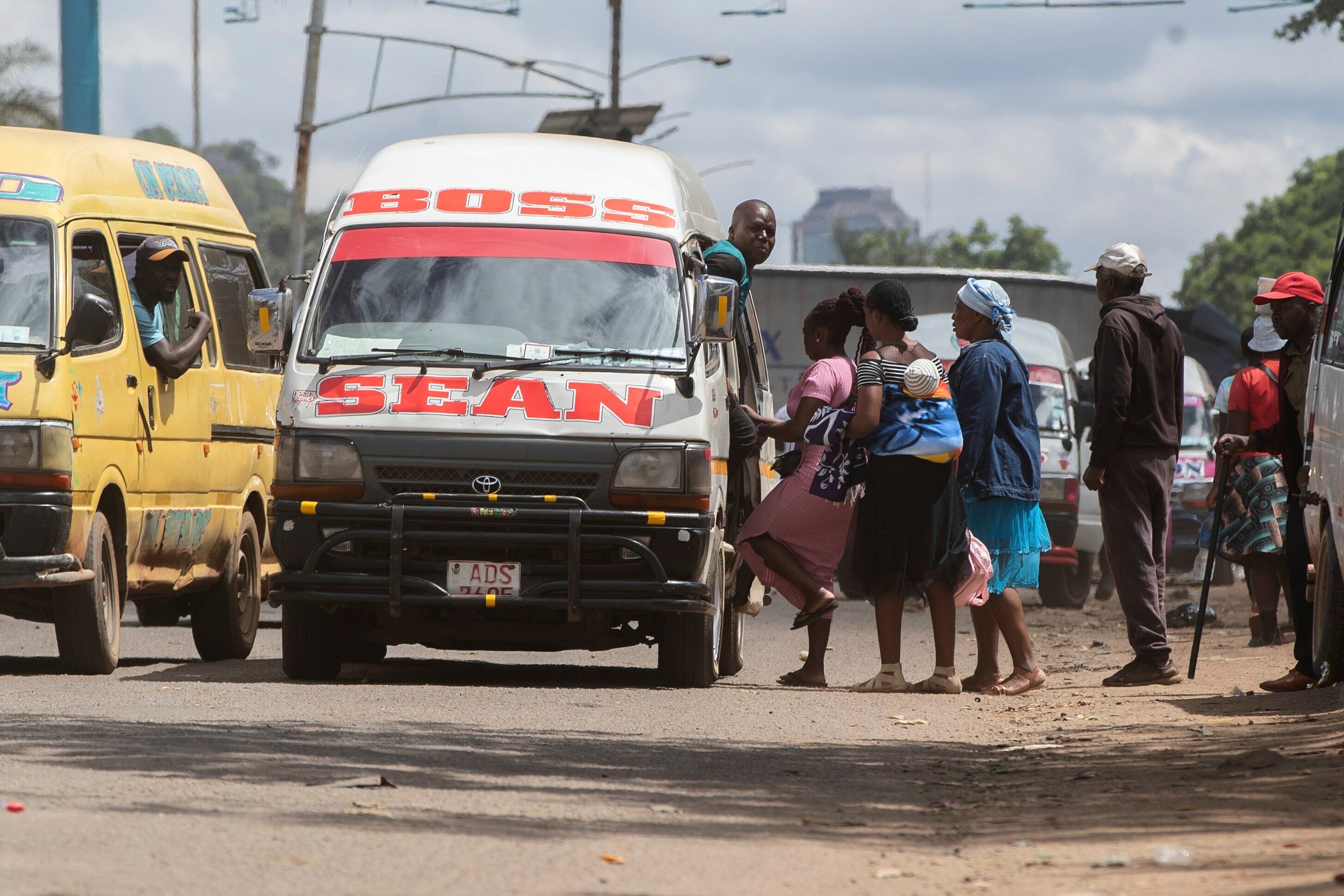 People board a minibus in Harare, Zimbabwe, Tuesday, Dec. 16, 2025. (AP Photo/Aaron Ufumeli)