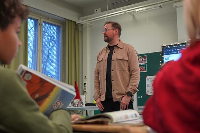 <p>Tapanila Primary School teacher and vice-principal Ville Vanhanen speaks to the fourth grade students during a media literacy class in Tapanila, Finland</p>