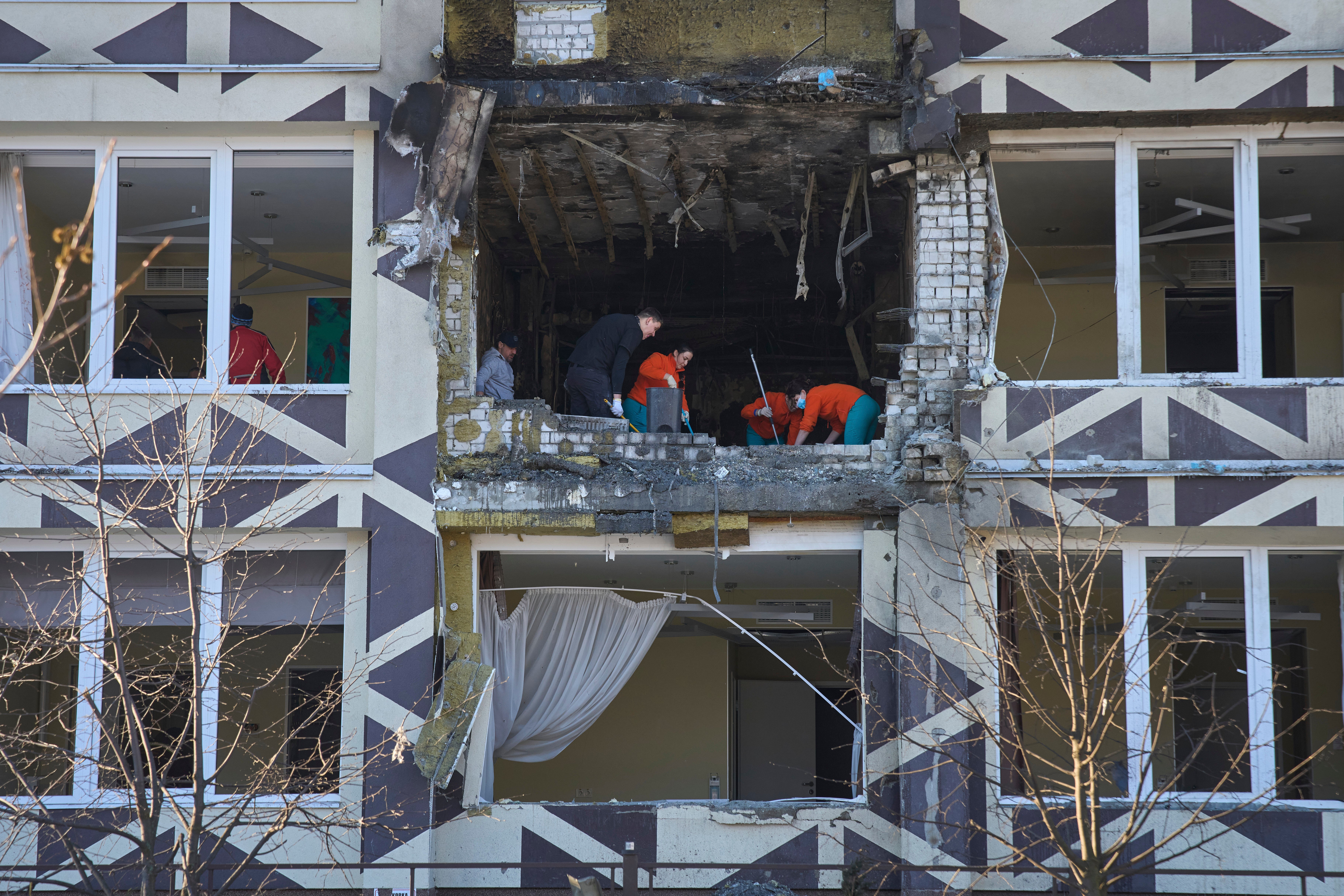 Medical workers remove the debris from the site on Monday