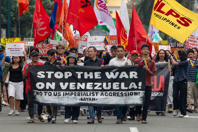 <p>Protesters with flags and a banner march during a demonstration condemning the US attack on Venezuela and the seizure of Venezuelan leader Nicolas Maduro</p>