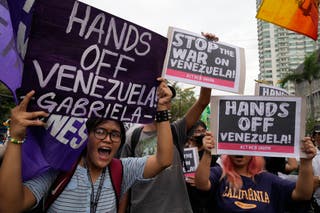 Protesters shout slogans as they denounce the U.S. government and U.S. President Donald Trump after the U.S. captured Venezuelan President Nicolas Maduro during a rally near the U.S. Embassy in Manila, Philippines on Monday,