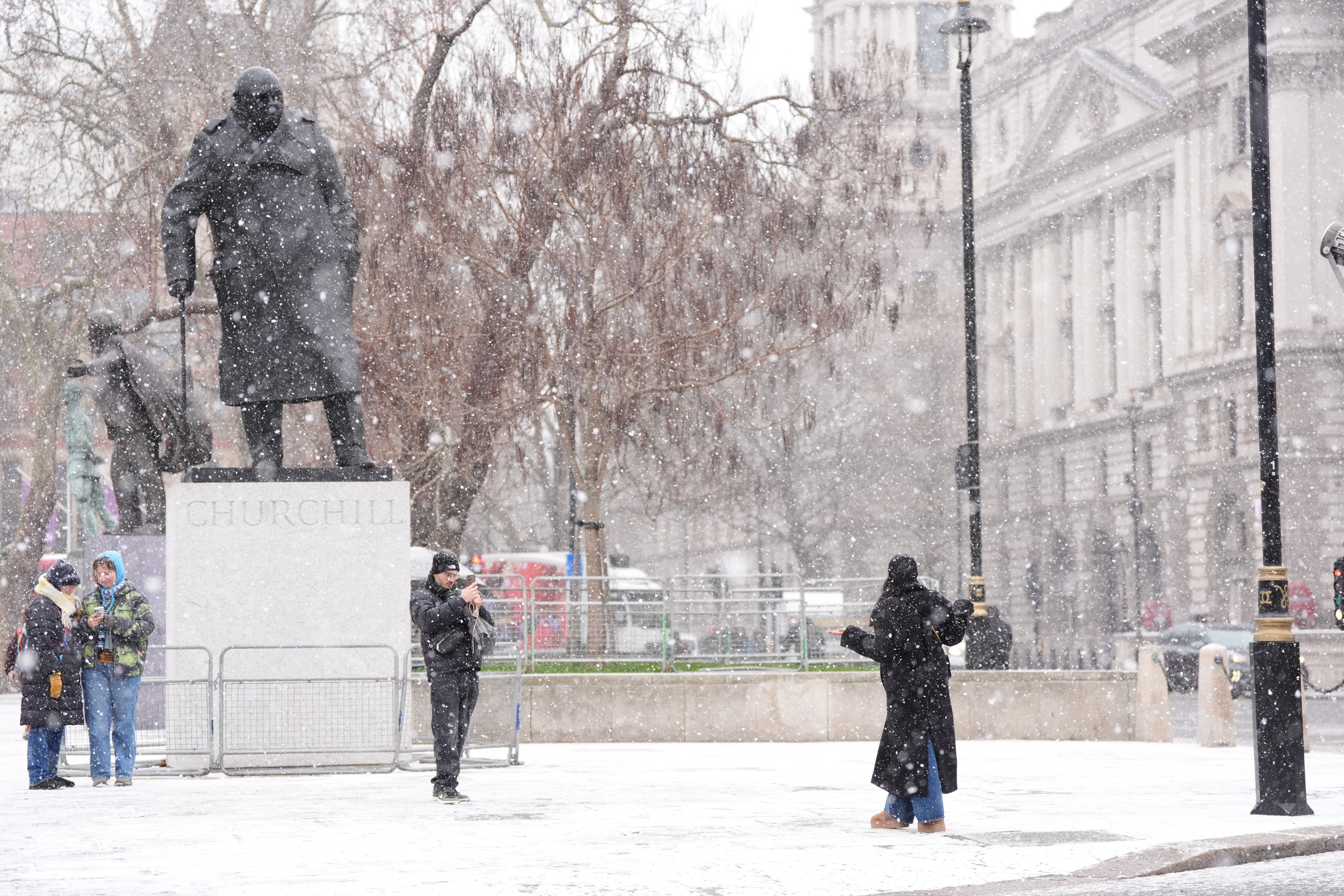 People in snowy conditions in Westminster, central London (Ben Whitley/PA)