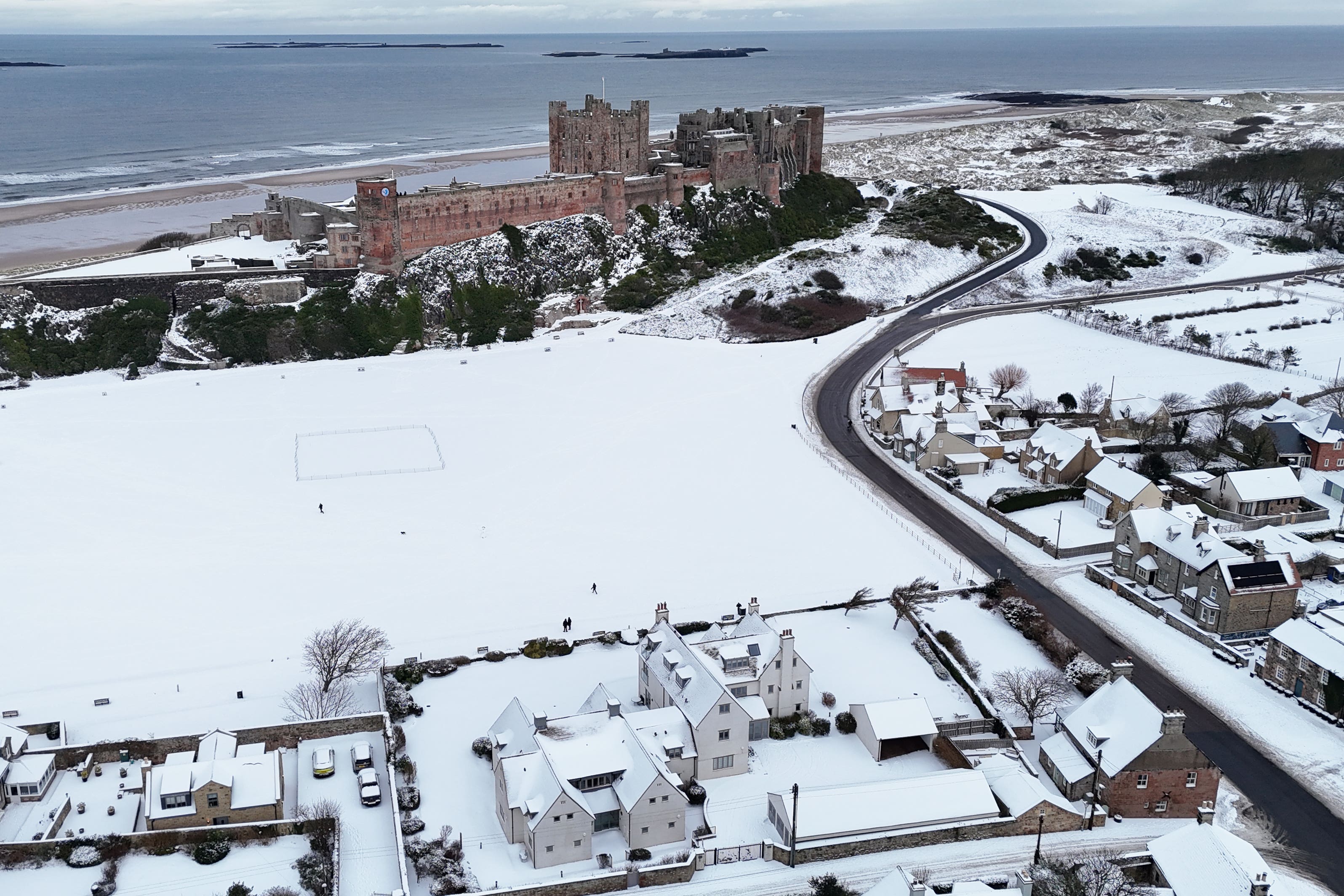 Bamburgh Castle surrounded by snow in Northumberland (Owen Humphreys/PA)
