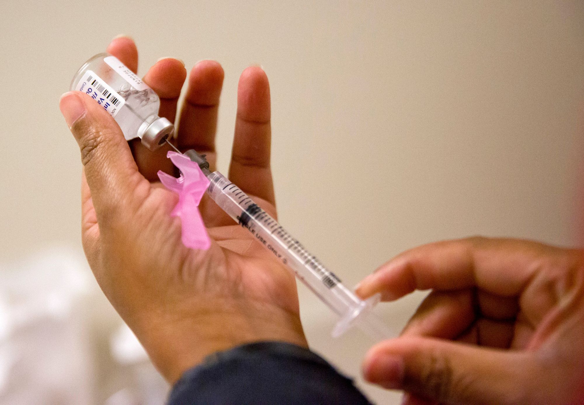 A nurse prepares a flu shot at the Salvation Army in Atlanta.