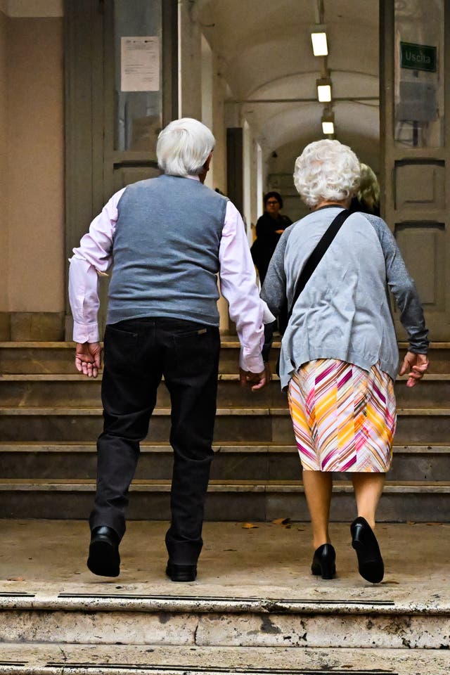 <p>File. An elderly couple arrive to cast their vote in Rome</p>