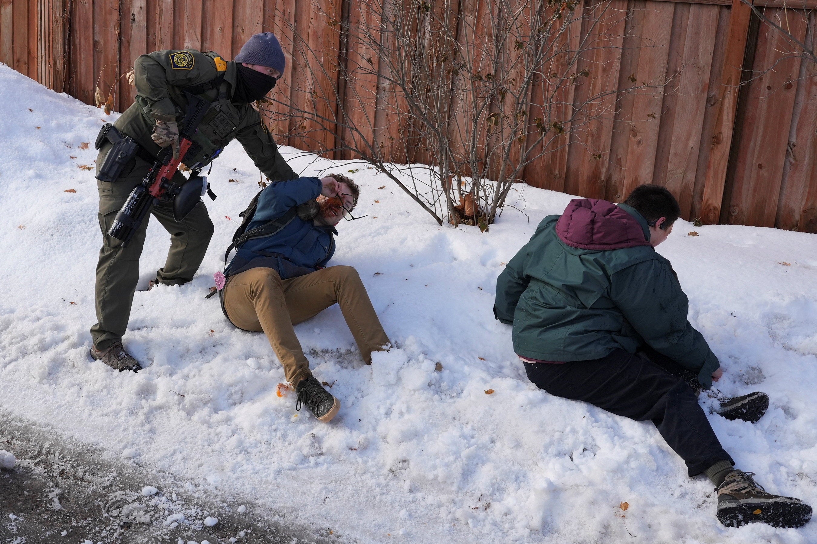 An ICE agent restrained protesters who were attempting to block vehicles from leaving the scene where a person was reportedly shot in Minneapolis