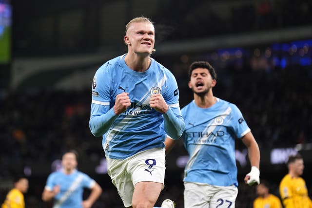 <p>Erling Haaland celebrates scoring his penalty against Brighton on Wednesday</p>