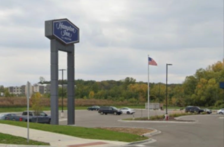 <p>A crane has removed a Hilton-branded sign at a hotel in Minnesota that has been accused of denying entry to Immigration and Customs Enforcement agents</p>