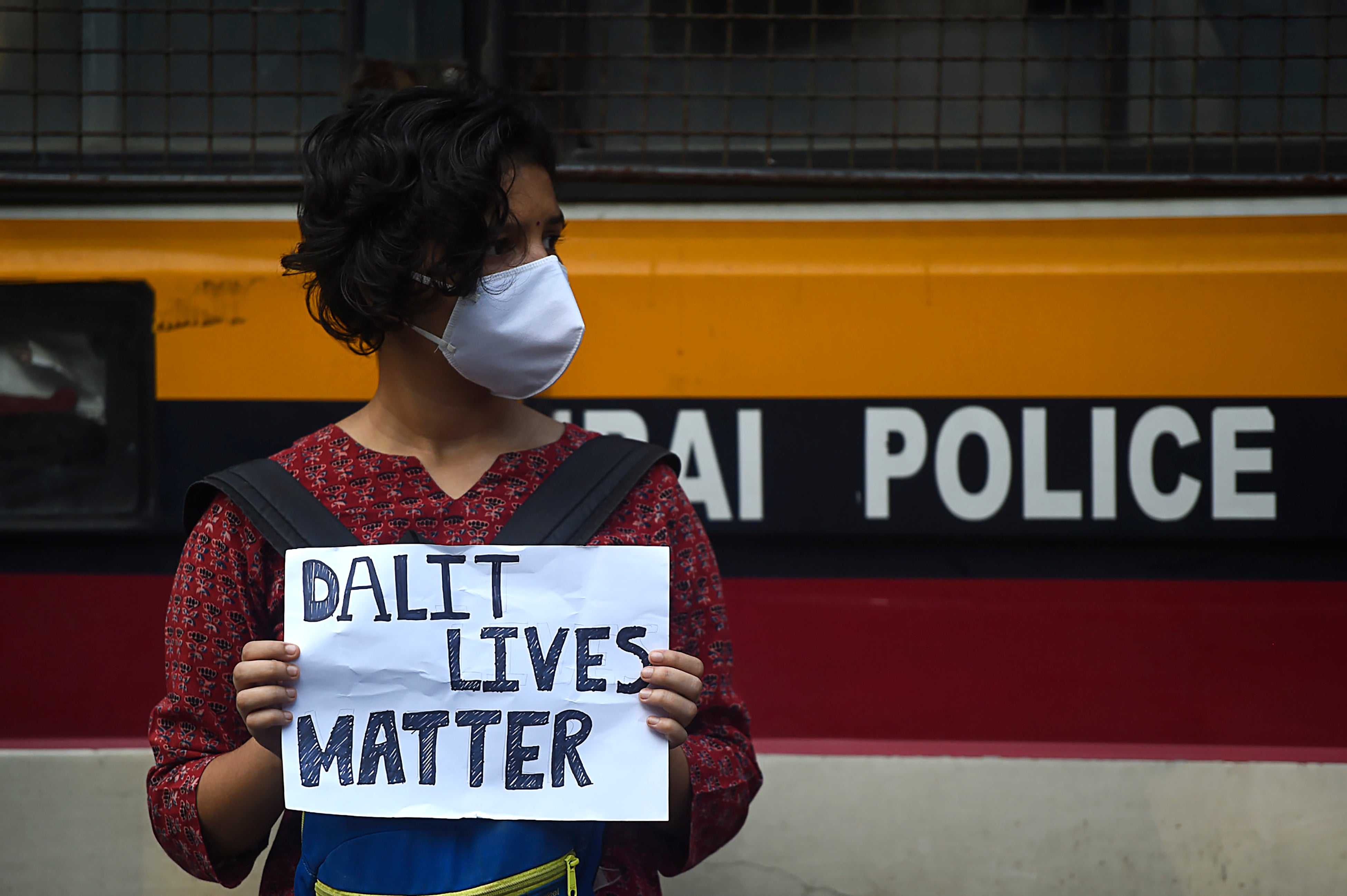 An activist holds a placard during a protest to condemn the alleged gang-rape and murder of a 19-year-old woman in Bool Garhi village of Uttar Pradesh state, in Mumbai on 6 October 2020