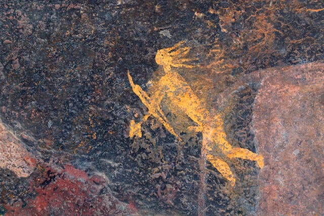 <p>Bushmen rock painting of a human figure with a hunting bow and arrow, South Africa</p>