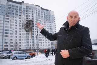 Defence Secretary John Healey meets emergency service workers at the scene of last night's drone attack which hit a residential area in the east of Kyiv, killing one person