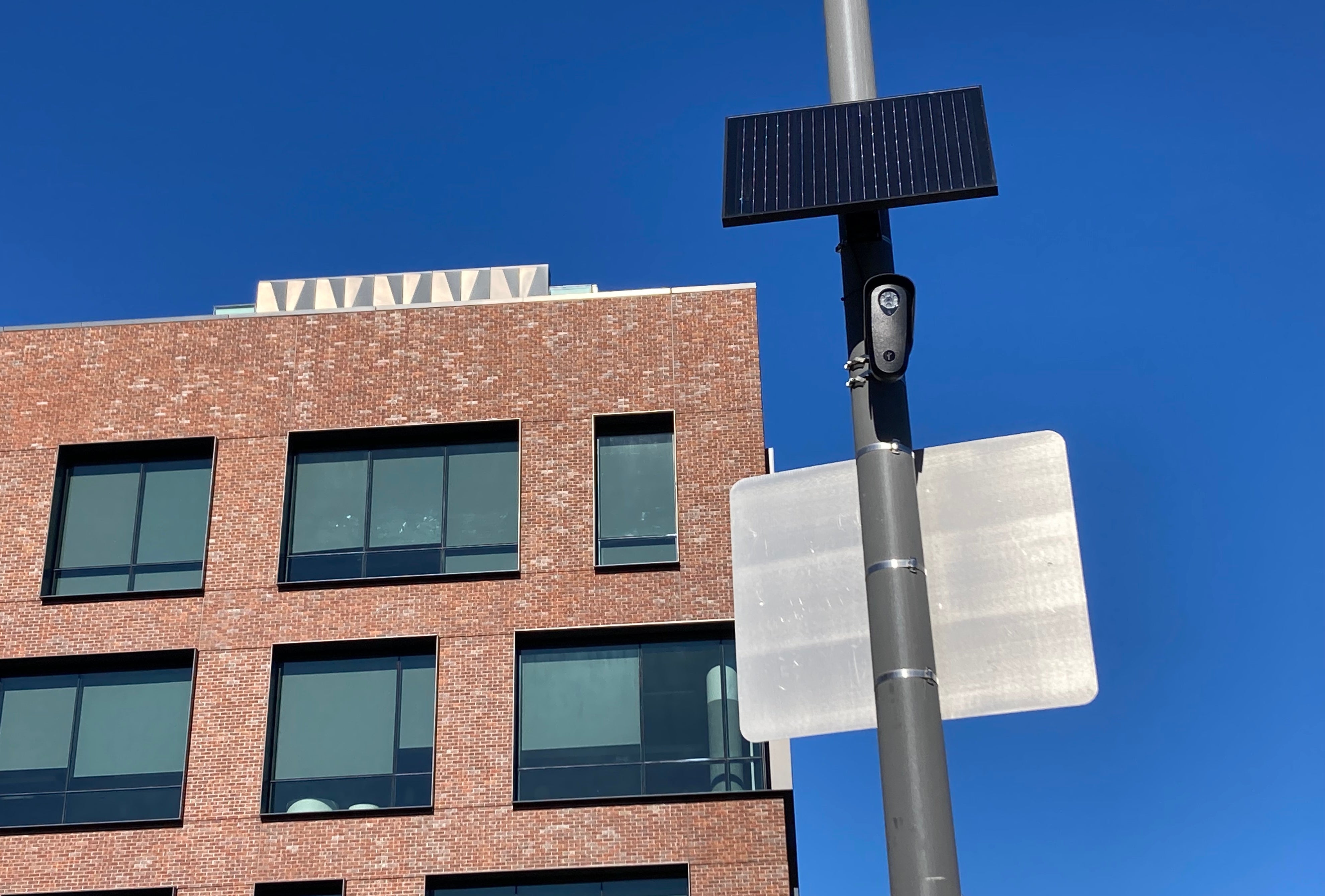 <p>A Flock automated license plate recognition camera watches an intersection near the campus of the University of California-San Francisco Benioff Children's Hospital. The data from the cameras is now being fed to ICE</p>
