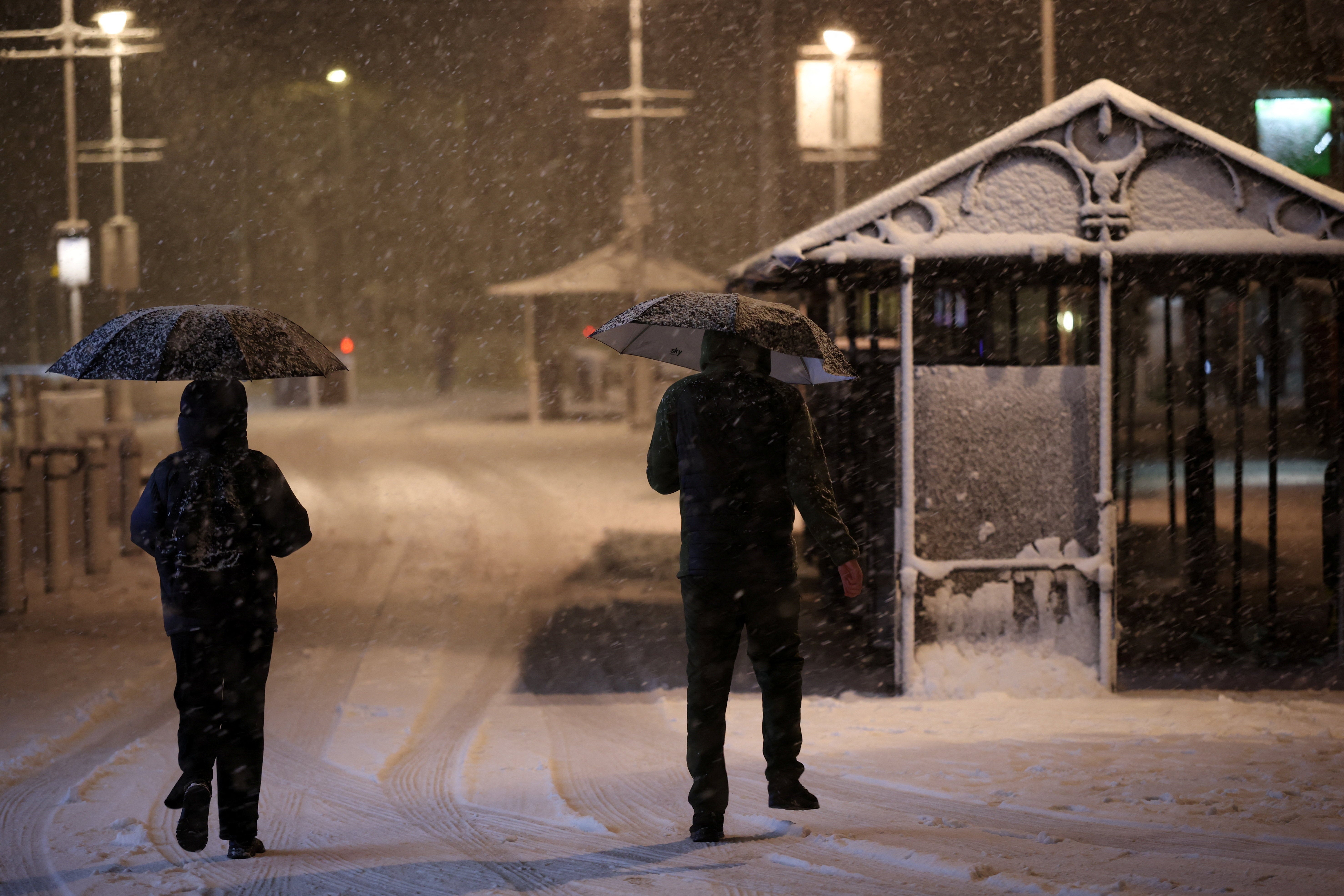 People shelter under umbrellas as Storm Goretti brings heavy snowfall and rain to Walsall, Britain, 8 January 2026