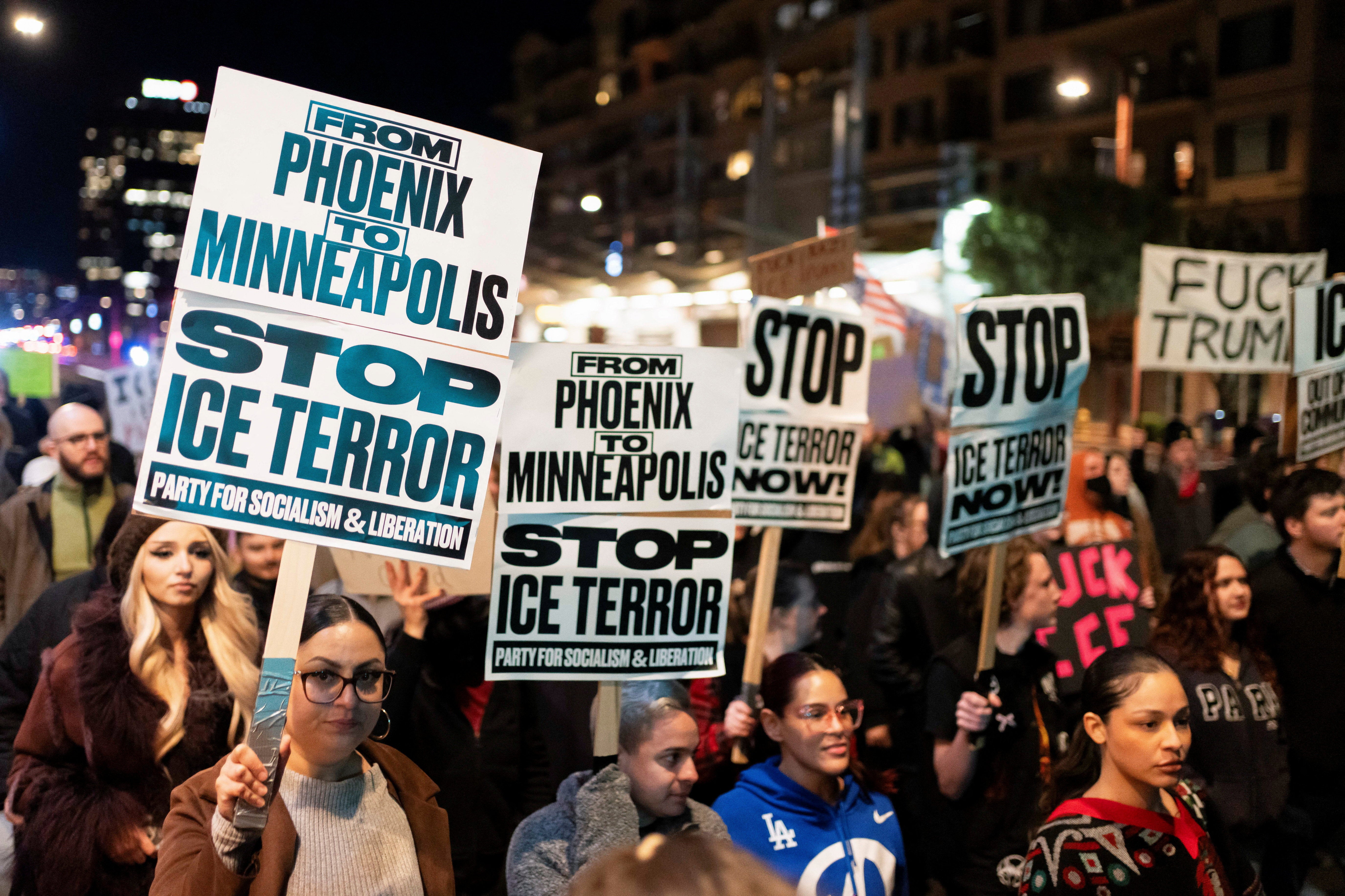People carry signs during a protest the day after the fatal shooting of Minneapolis resident Renee Nicole Good by a U.S. Immigration and Customs Enforcement (ICE) agent