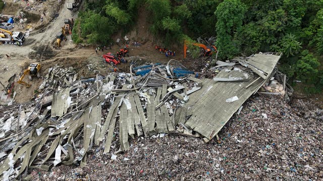 <p>Rescuers search for missing workers at a collapsed waste segregation facility in Cebu City</p>